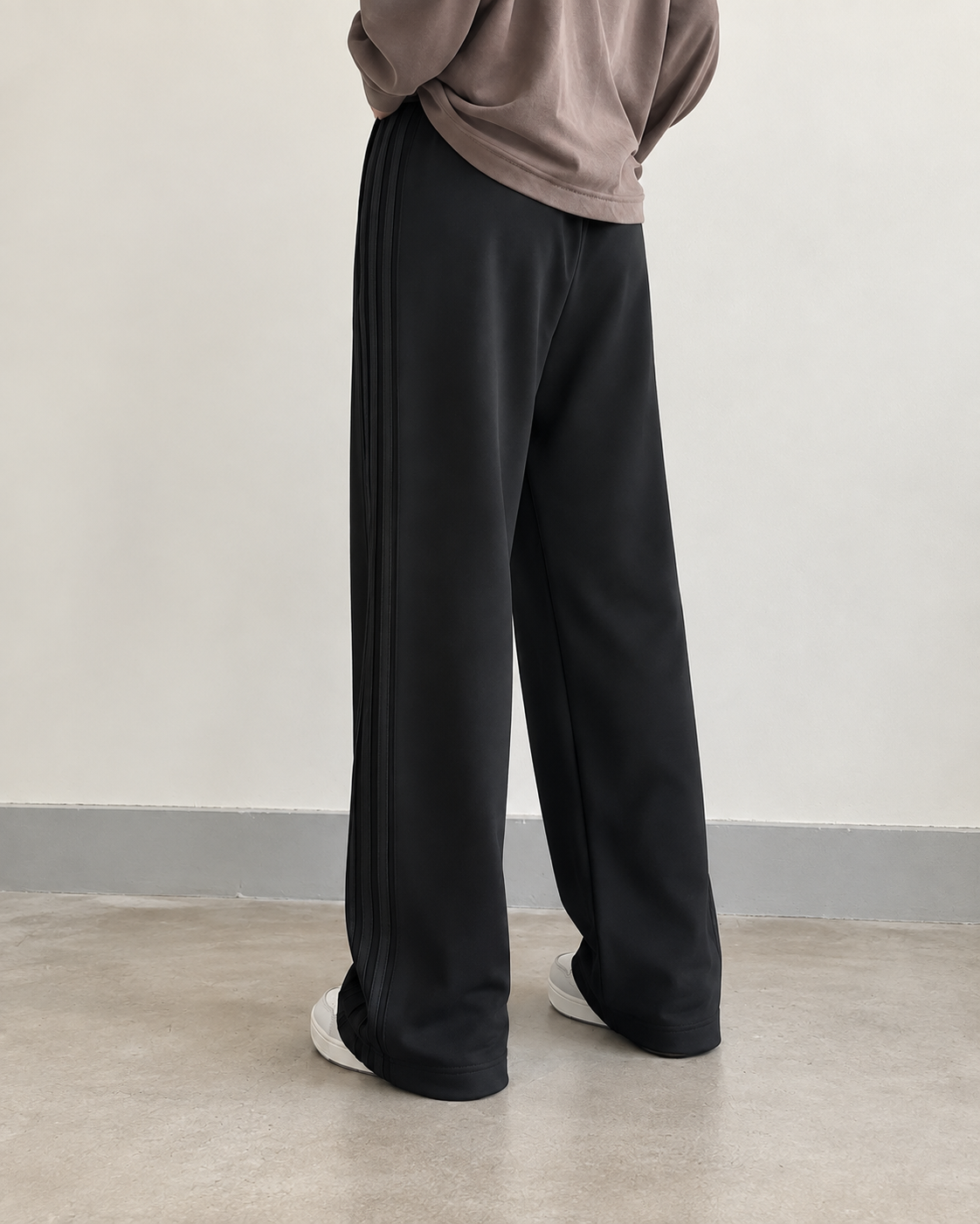 Black high-waisted side-seam wide-leg trousers — side