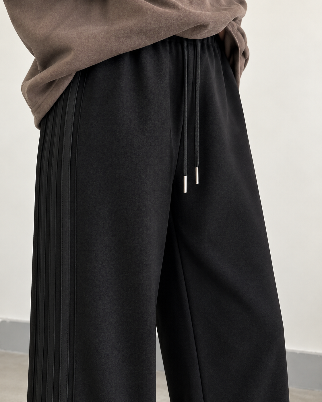 Black high-waisted side-seam wide-leg trousers — waistband